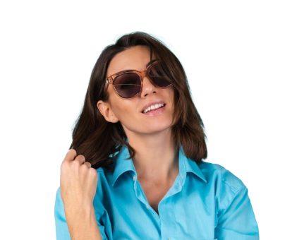 A woman in a blue shirt wearing sunglasses smiles confidently.