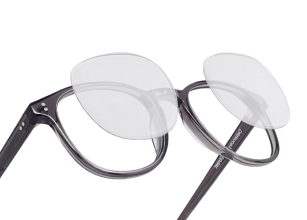 A pair of glasses with lenses that flip upward.