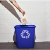 Person placing a cup into a blue recycling bin with a recycling symbol.