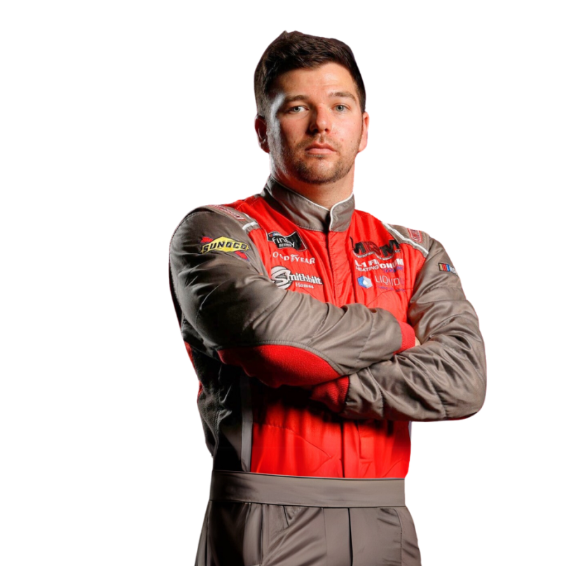 Race car driver in a red and gray racing suit with arms crossed.