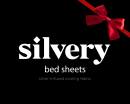 'Silvery bed sheets advertisement with red ribbon on black background.'