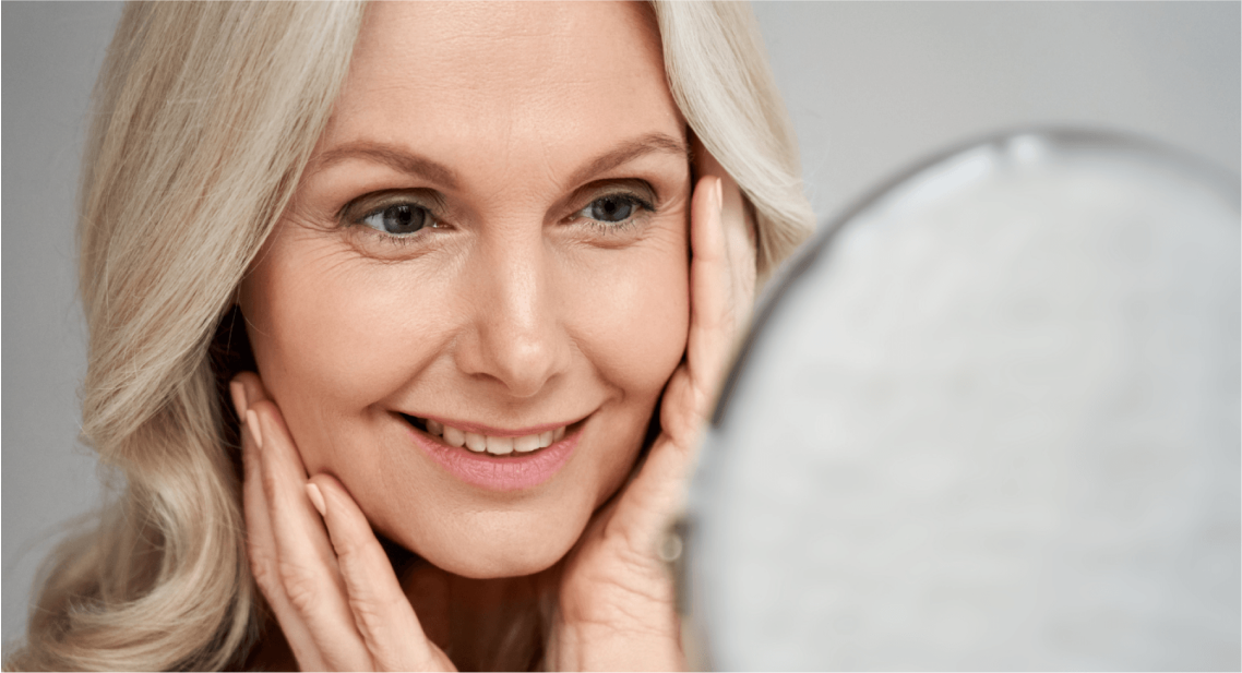 Woman smiling while looking in a mirror.