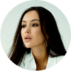 Portrait of a woman with long hair, wearing a white blouse.