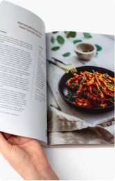 Open cookbook displaying a recipe and a colorful dish photograph.