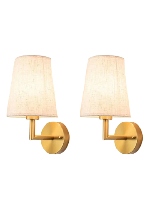 Two brass wall sconces with beige fabric lampshades.