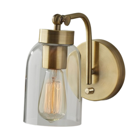 Wall-mounted brass lamp with clear glass shade and visible Edison bulb.