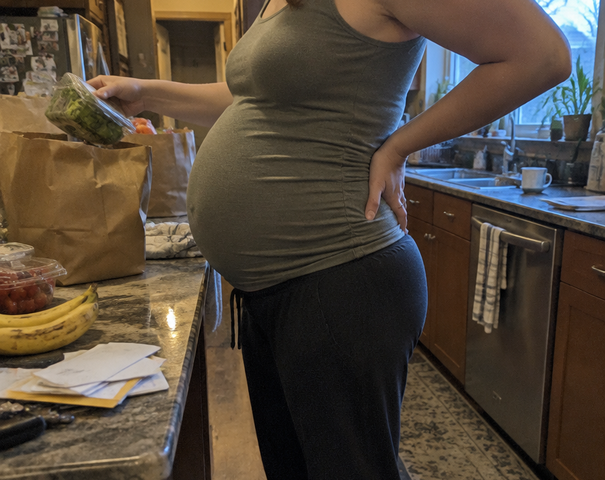 Pregnant women emptying the groceries in the kitchen