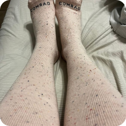Customer wearing speckled pink Comrad knee-high socks
