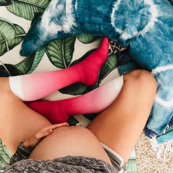 Pregnant woman sitting with Comrad compression socks on