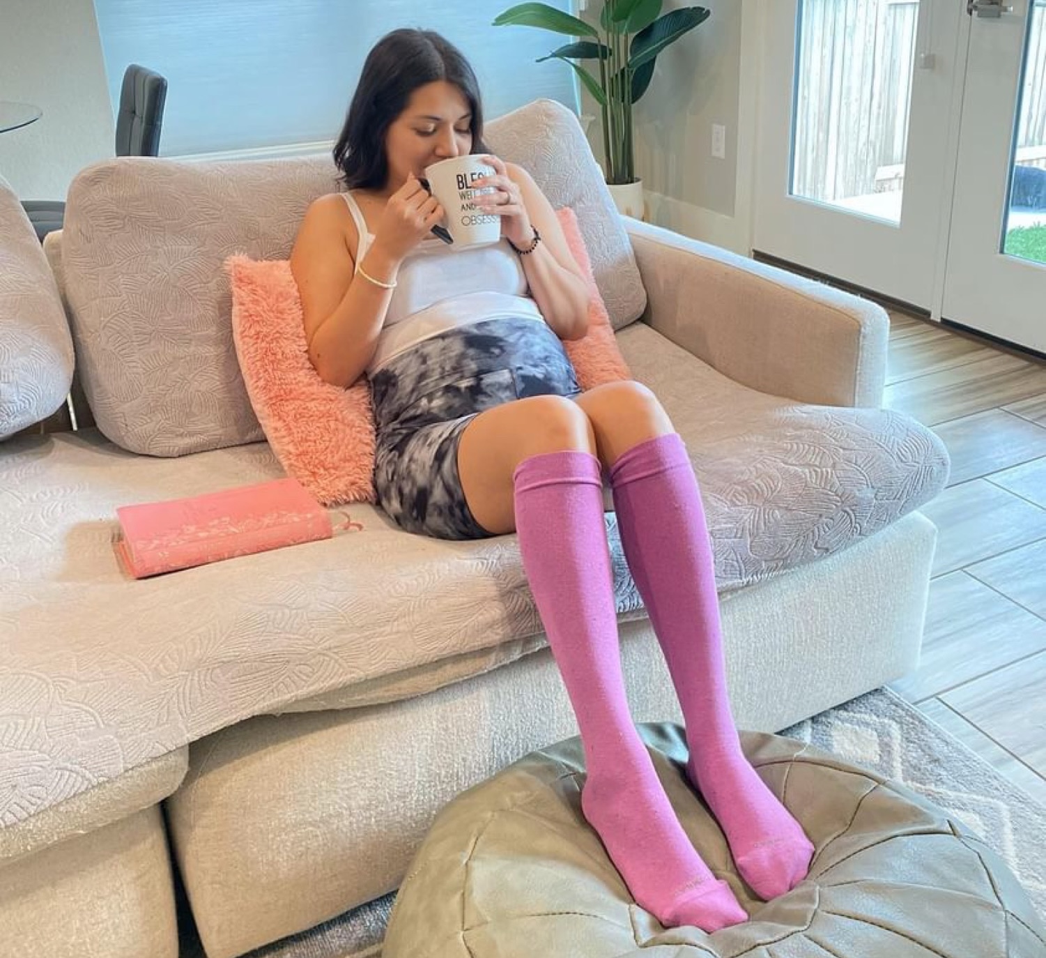 Pregnant woman sitting with Comrad compression socks