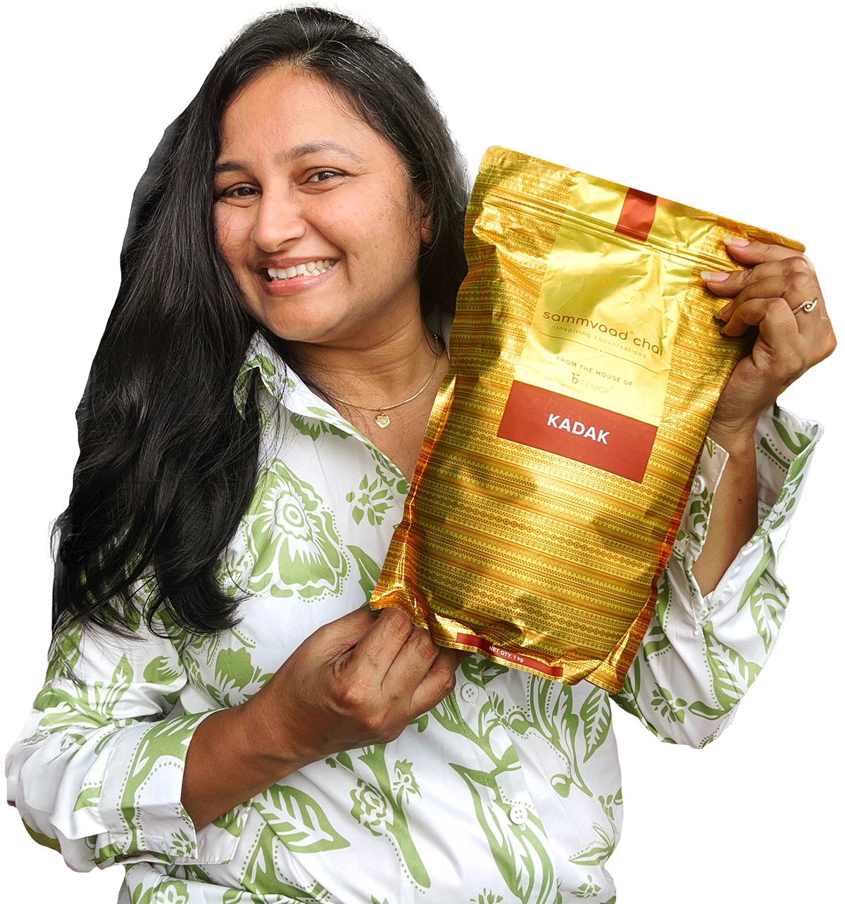Person smiling and holding a gold and red package labeled 'Kadak.'