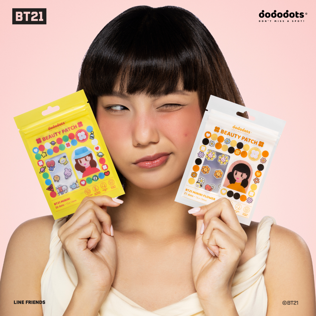 A woman with bangs winks while holding two different packages of BT21 Beauty Patches.
