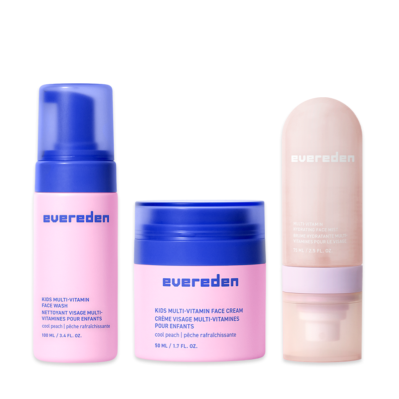 Three Evereden kids' skincare products in pink and blue containers: a face wash, face cream, and hydrating mist.