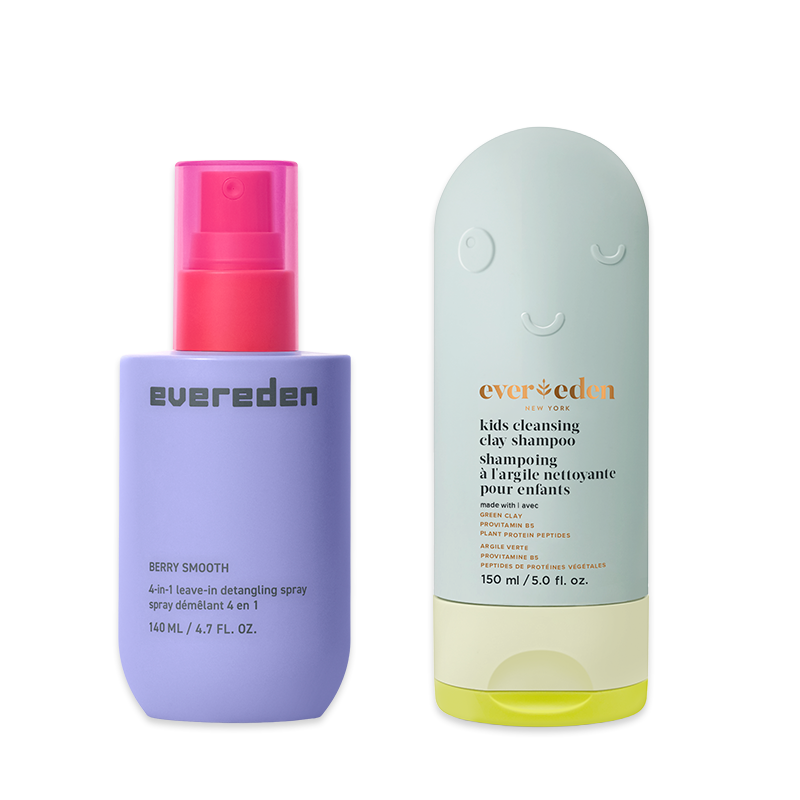 A purple bottle of Evereden detangling spray next to a green bottle of their kids cleansing clay shampoo.