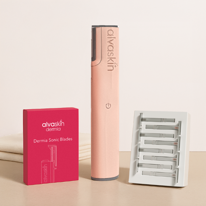 Pink skincare device beside red box and white blade holder.