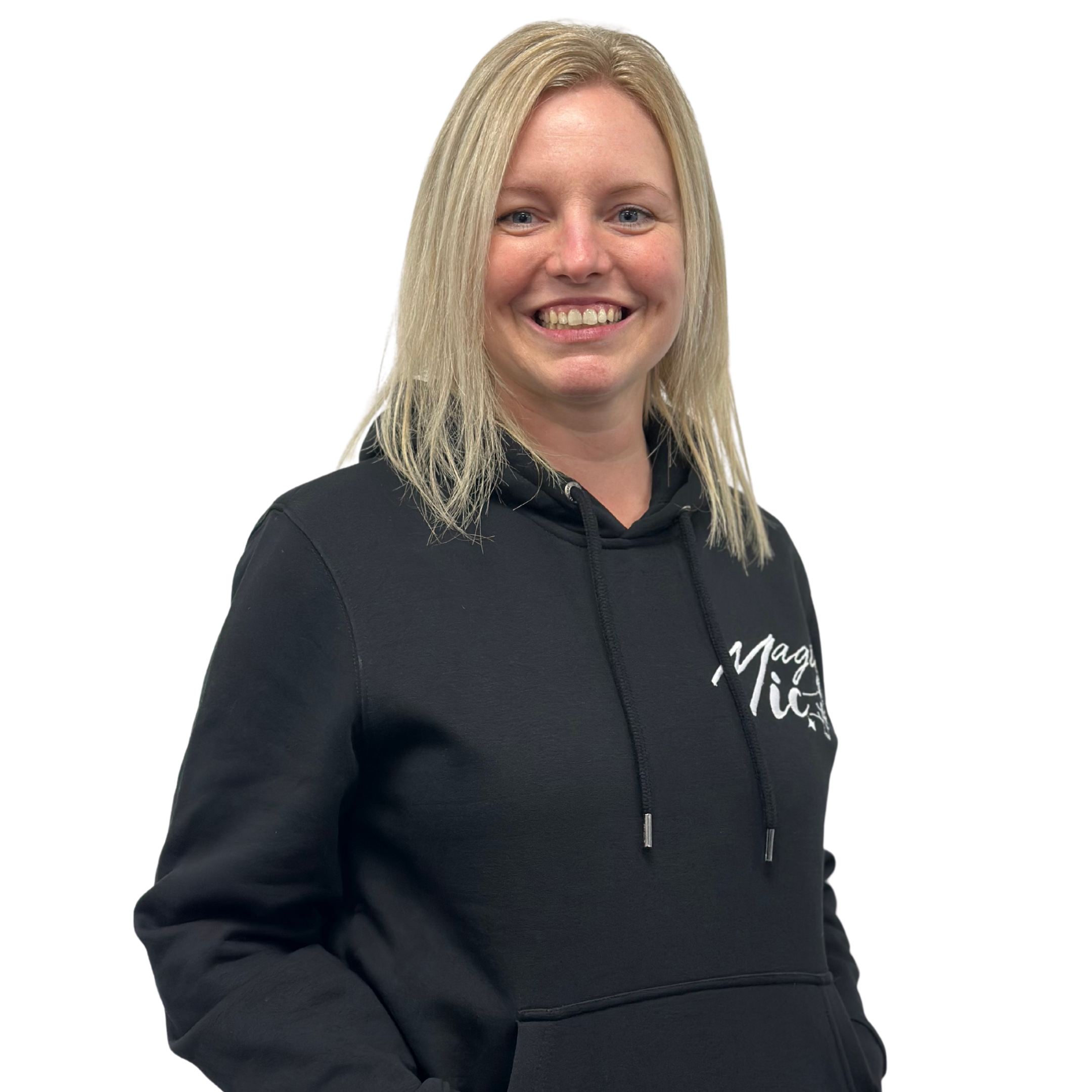 Person smiling, wearing a black hoodie with text, on a plain background.