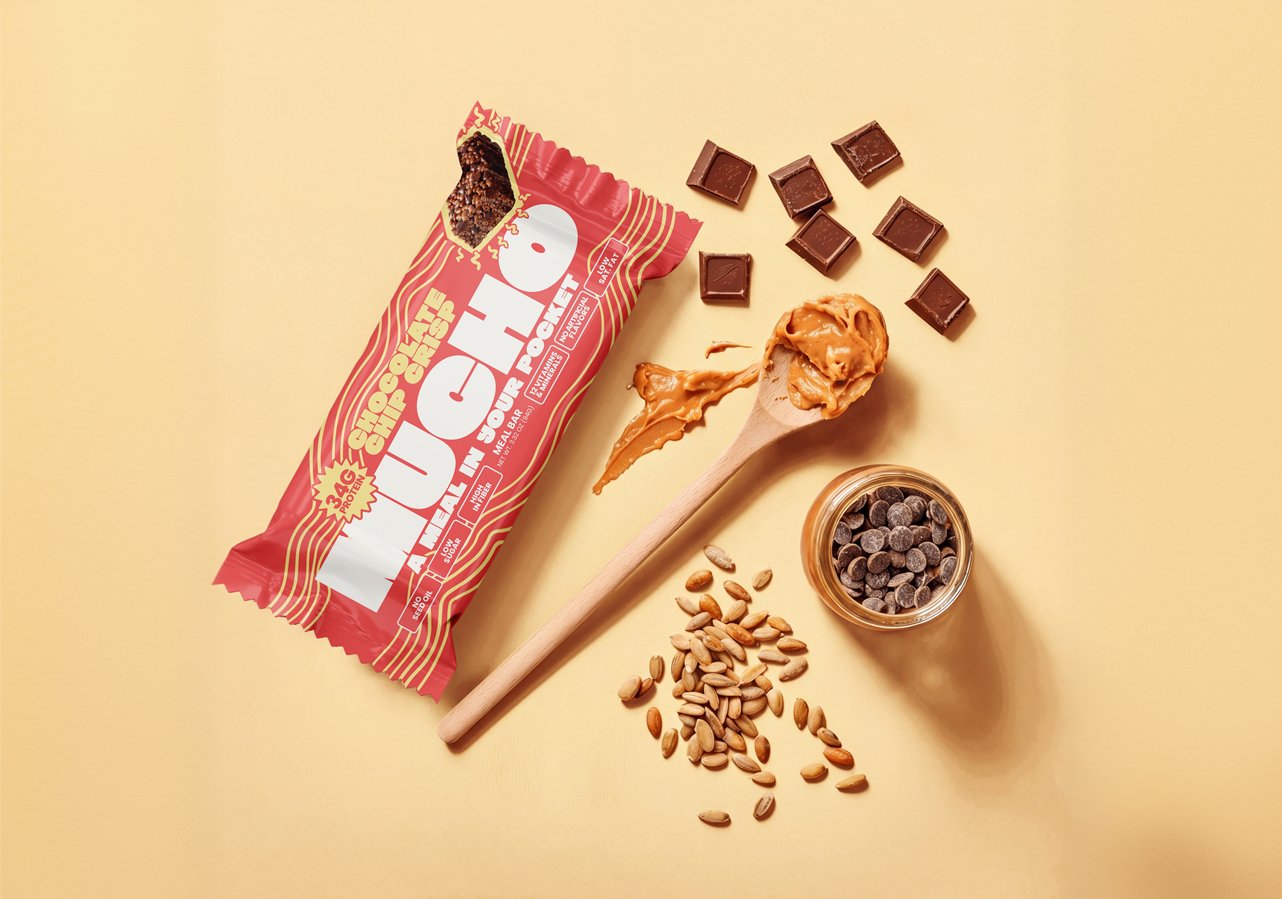 A Mucho meal bar is laid flat with its ingredients: chocolate, peanut butter, seeds, and chocolate chips.