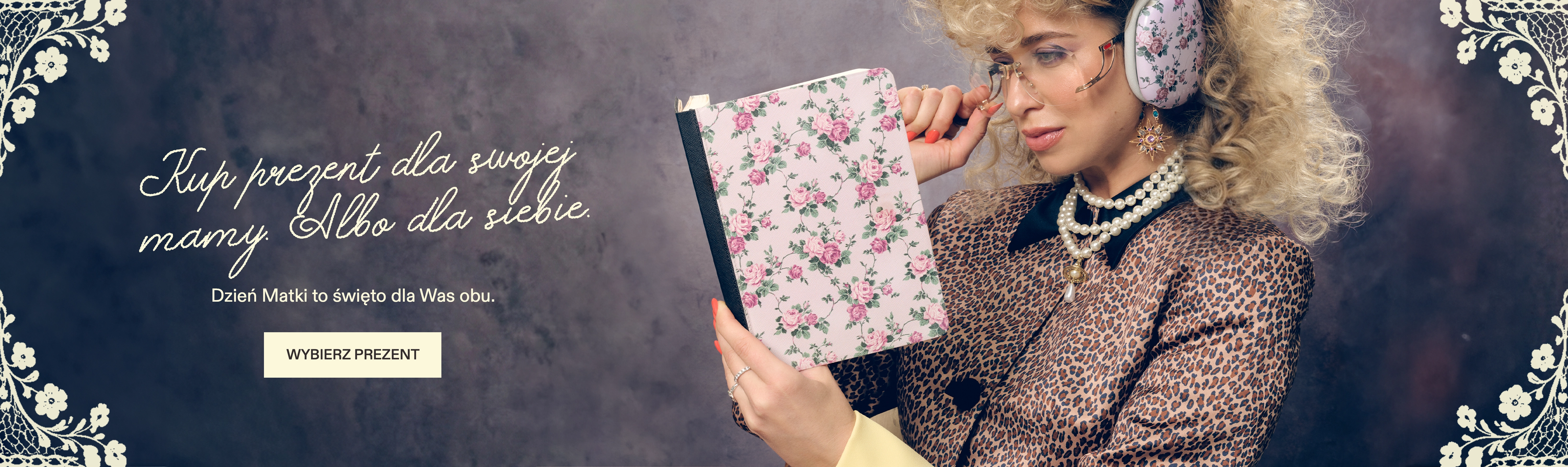 A woman in retro fashion, holding a floral notebook and wearing matching floral earmuffs.