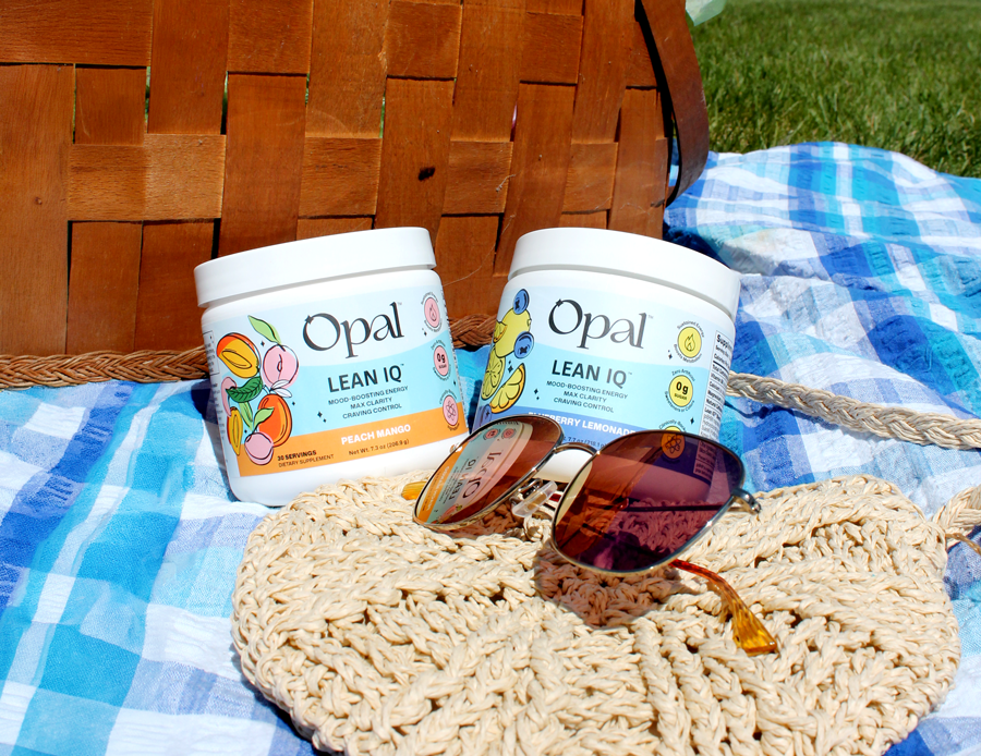Two jars of Opal Lean IQ supplement powder on a picnic blanket with a basket and sunglasses.