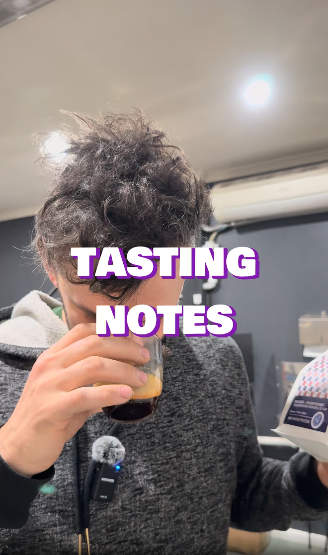 Person smelling coffee with 'TASTING NOTES' text overlay.