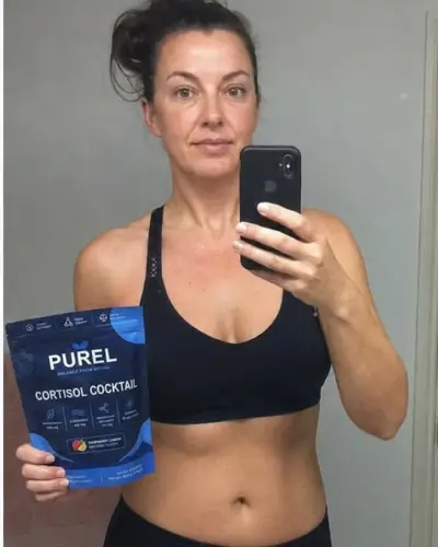 A woman in a sports bra takes a selfie while holding a bag of Purel Cortisol Cocktail.