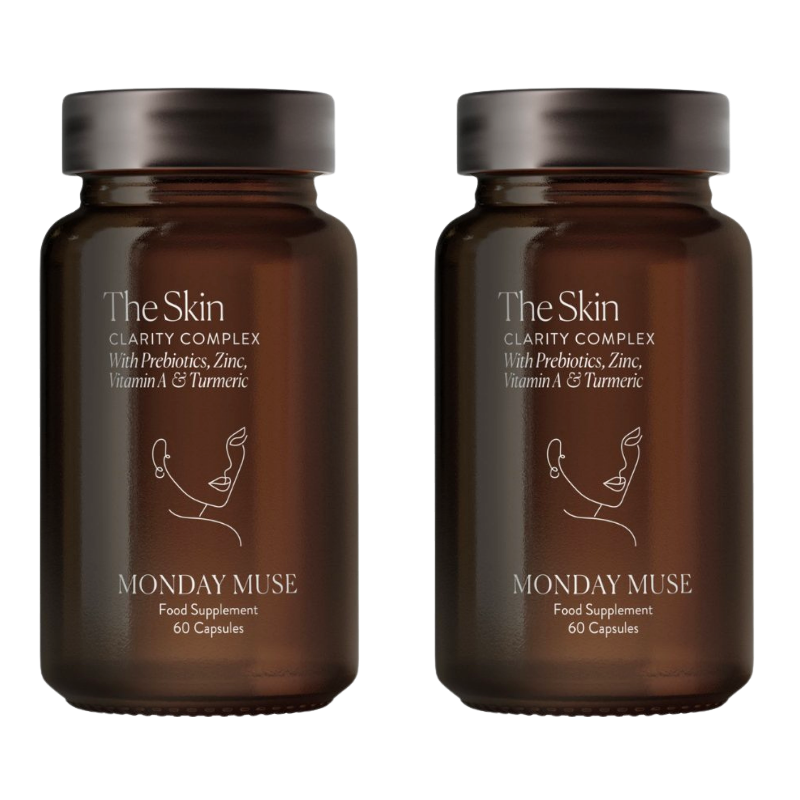 Two identical brown glass bottles of Monday Muse's The Skin Clarity Complex supplement on a white background.