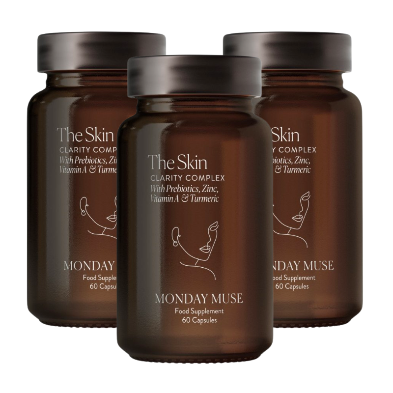 Three brown glass bottles of Monday Muse's The Skin Clarity Complex food supplement against a white background.