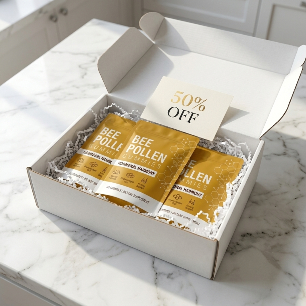 An open white box with pouches of Bee Pollen Gummies and a 50% off card on a marble surface.