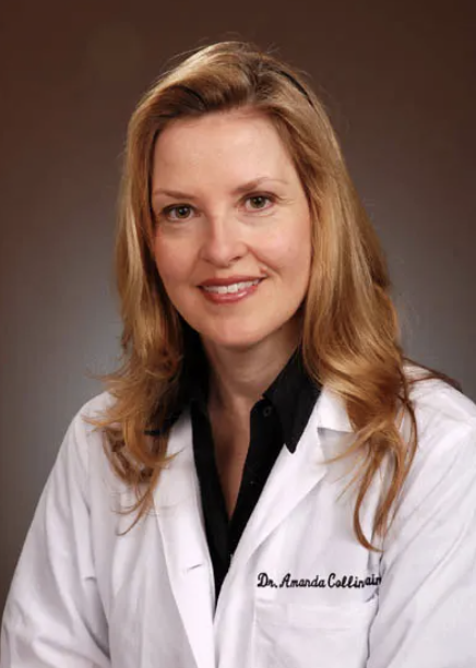 Woman in a white coat with a name embroidered.