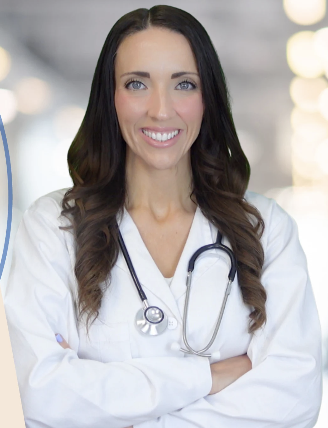 Smiling woman in a white coat with a stethoscope around her neck.
