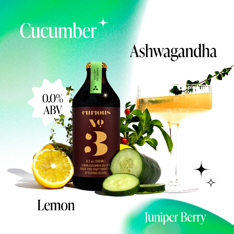 A bottle of Curious No. 3 non-alcoholic cocktail with a coupe glass, lemon, cucumber, and herbs.