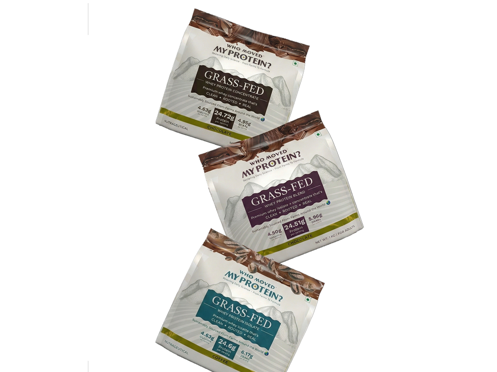 Three packets of grass-fed protein on a black background.
