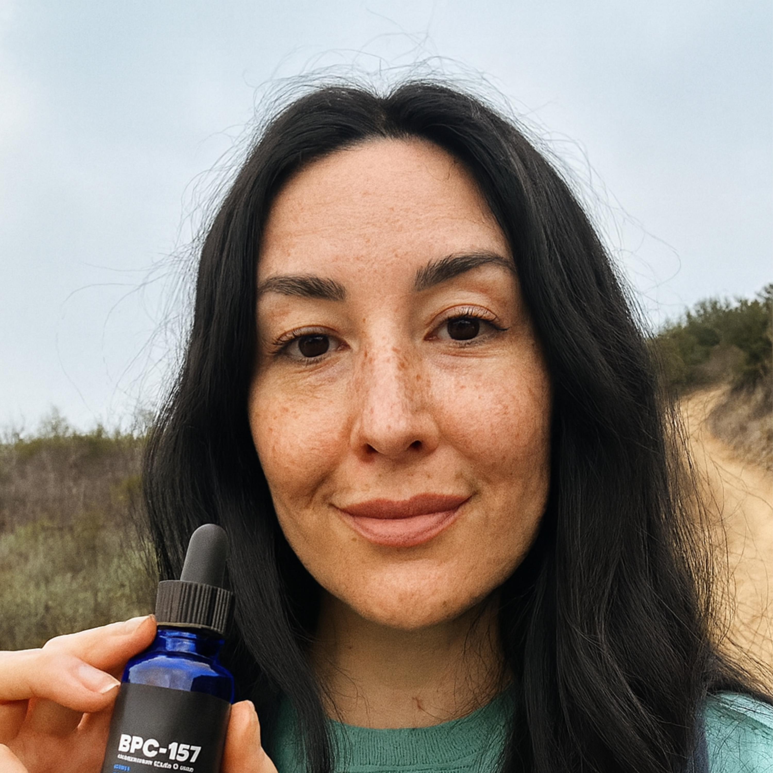 Person holding a blue bottle labeled BPC-157 outdoors.