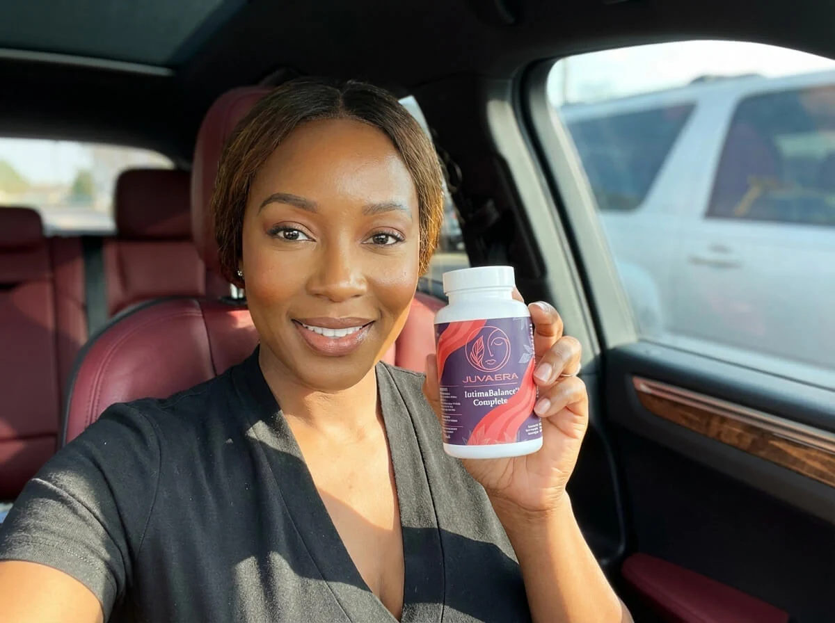 A smiling woman sitting in a car holds up a white bottle of Juvaera supplements.