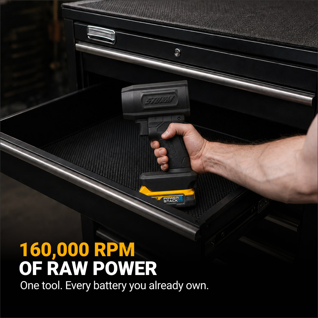 A hand holds a black Storm power tool with a yellow battery over an open toolbox drawer.