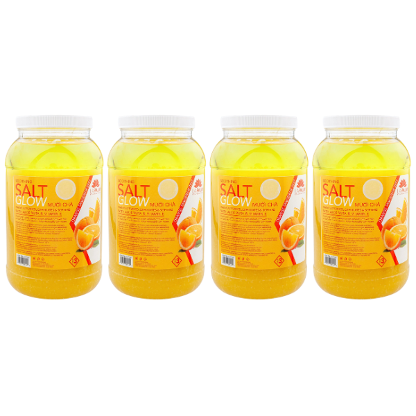 Four jars of yellow salt glow scrub with orange labels.