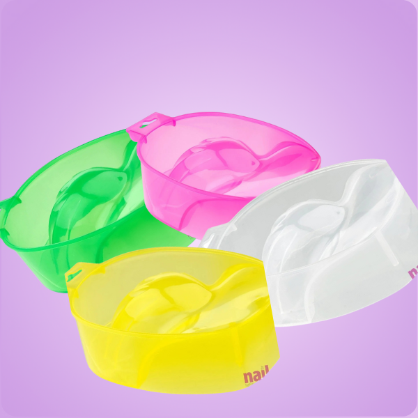 Four colorful plastic nail soak bowls on a purple background.