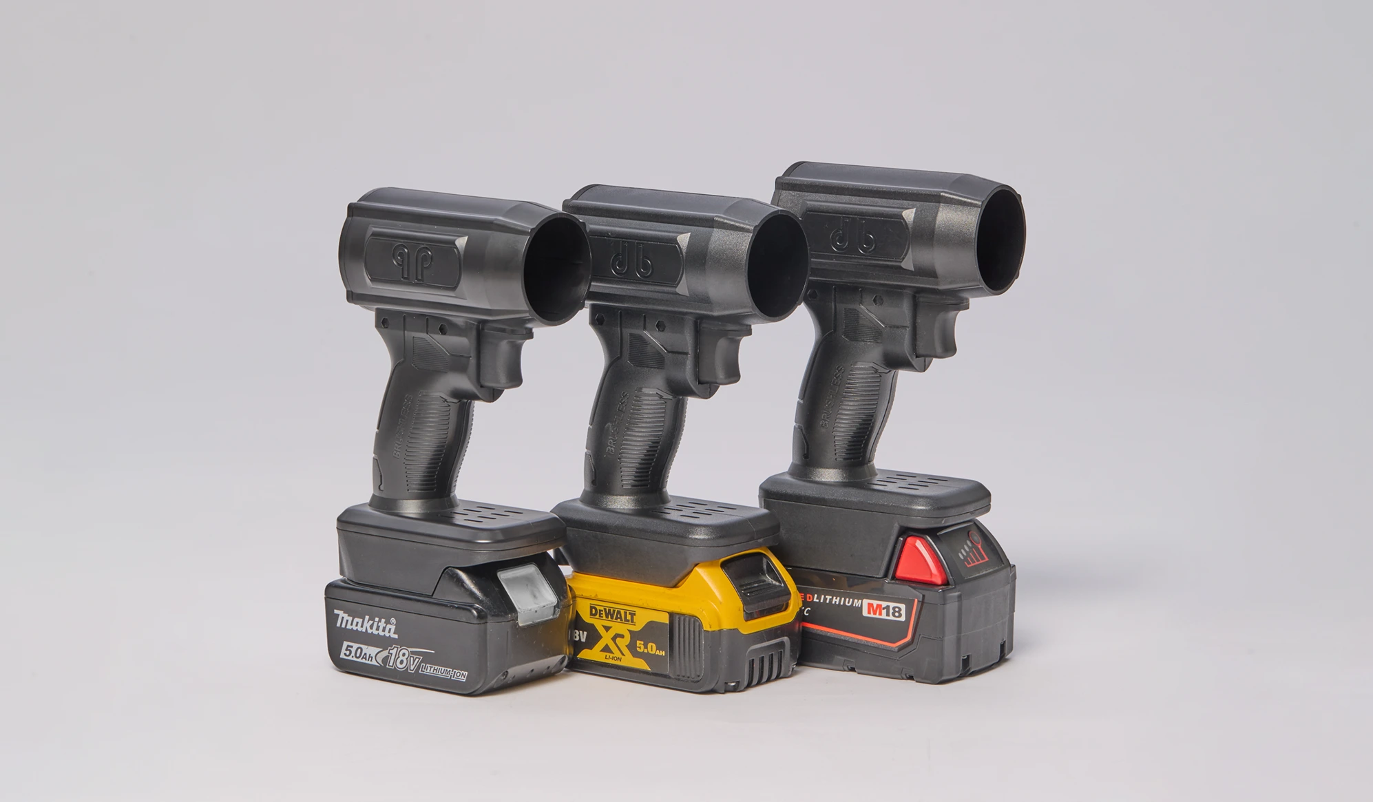 Three drill handle structures with batteries attached in a row.