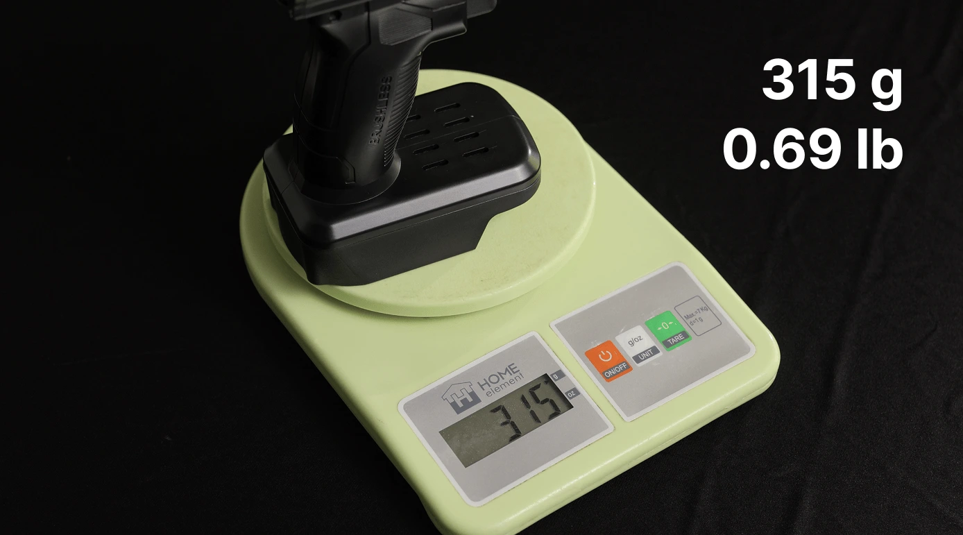 A black drill on a green digital scale displaying 315 grams.