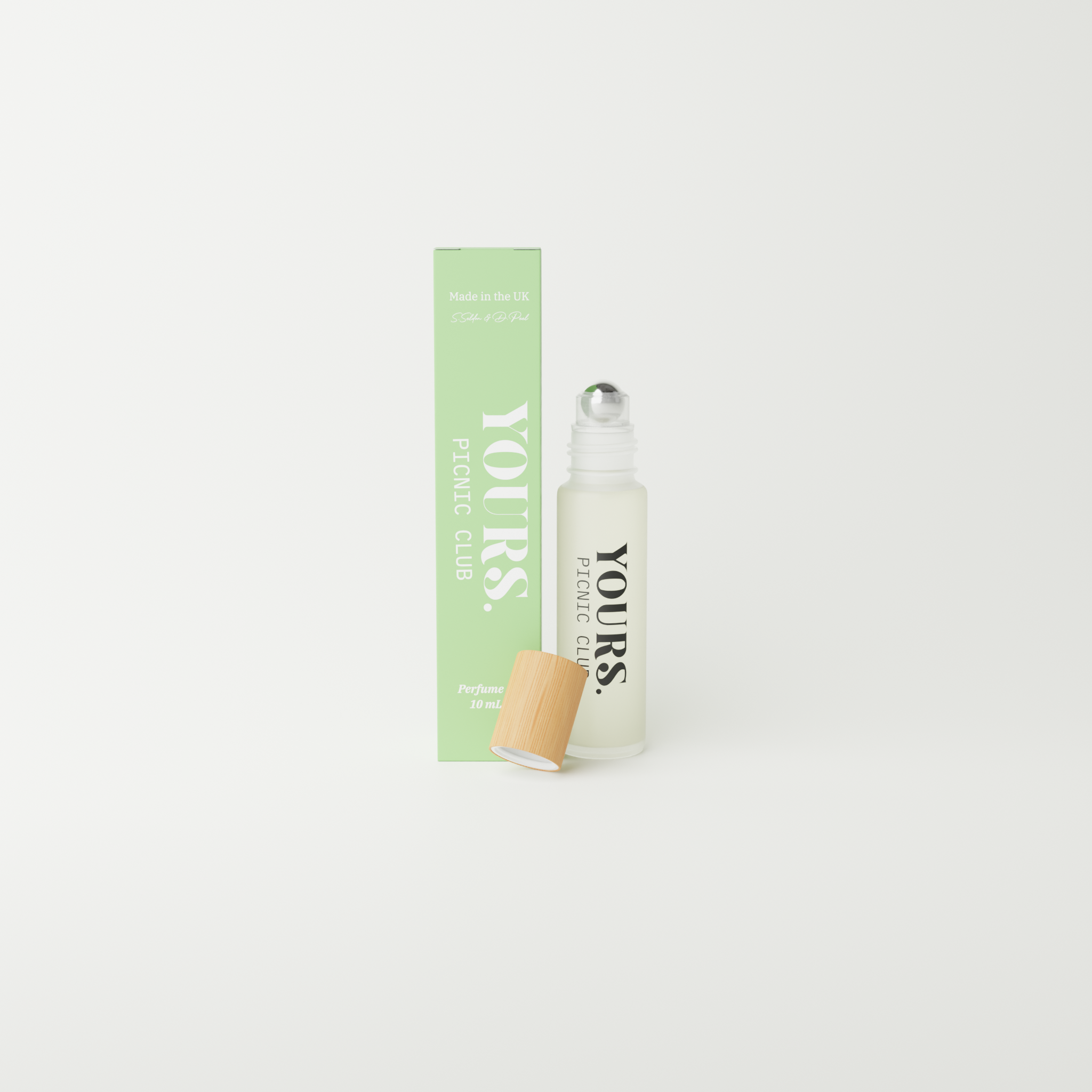 Perfume bottle with green box labeled 'YOURS PICNIC CLUB' on white background.