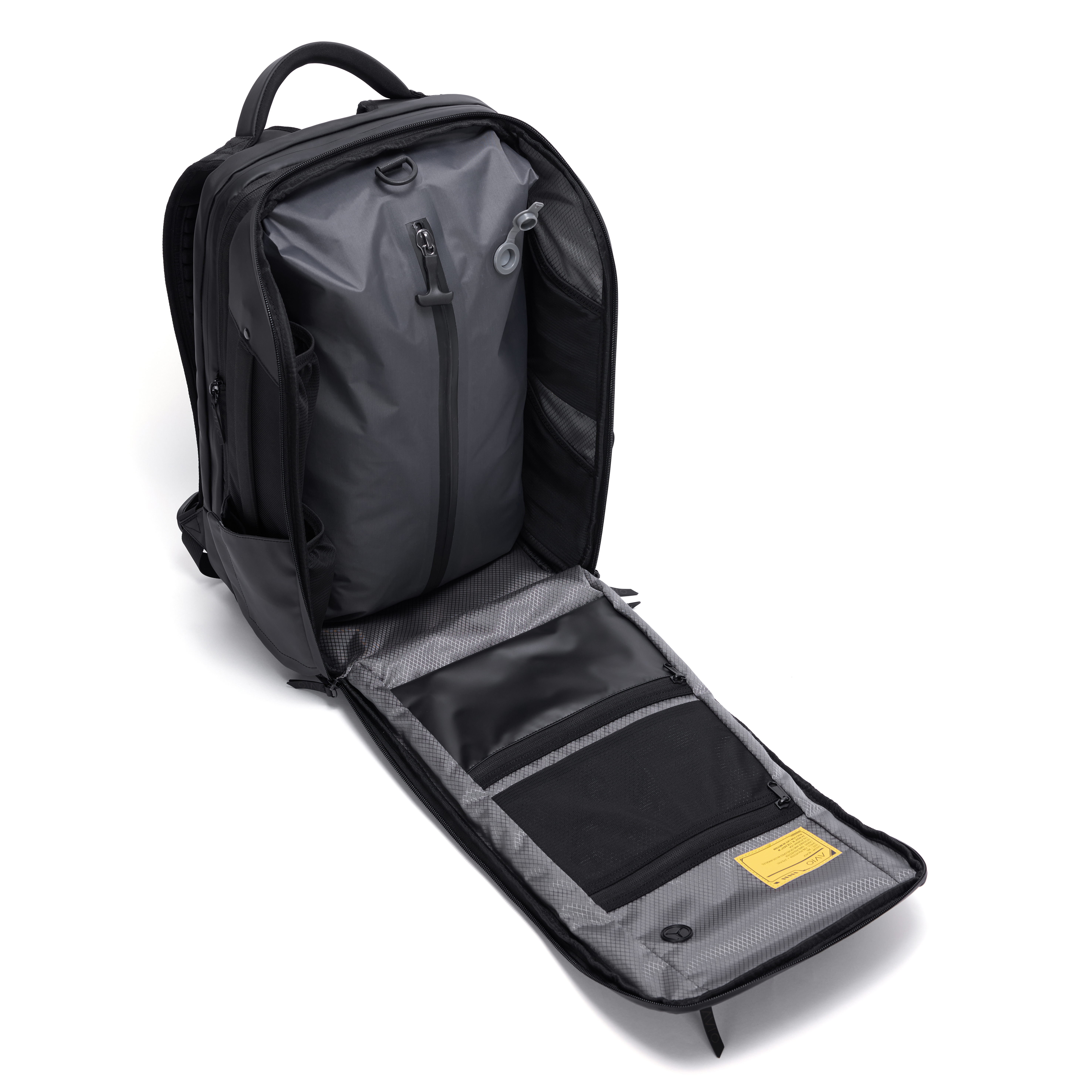 Open black backpack with multiple compartments and zippers.