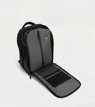 A black backpack unzipped to show the interior compartments and pockets against a white background.