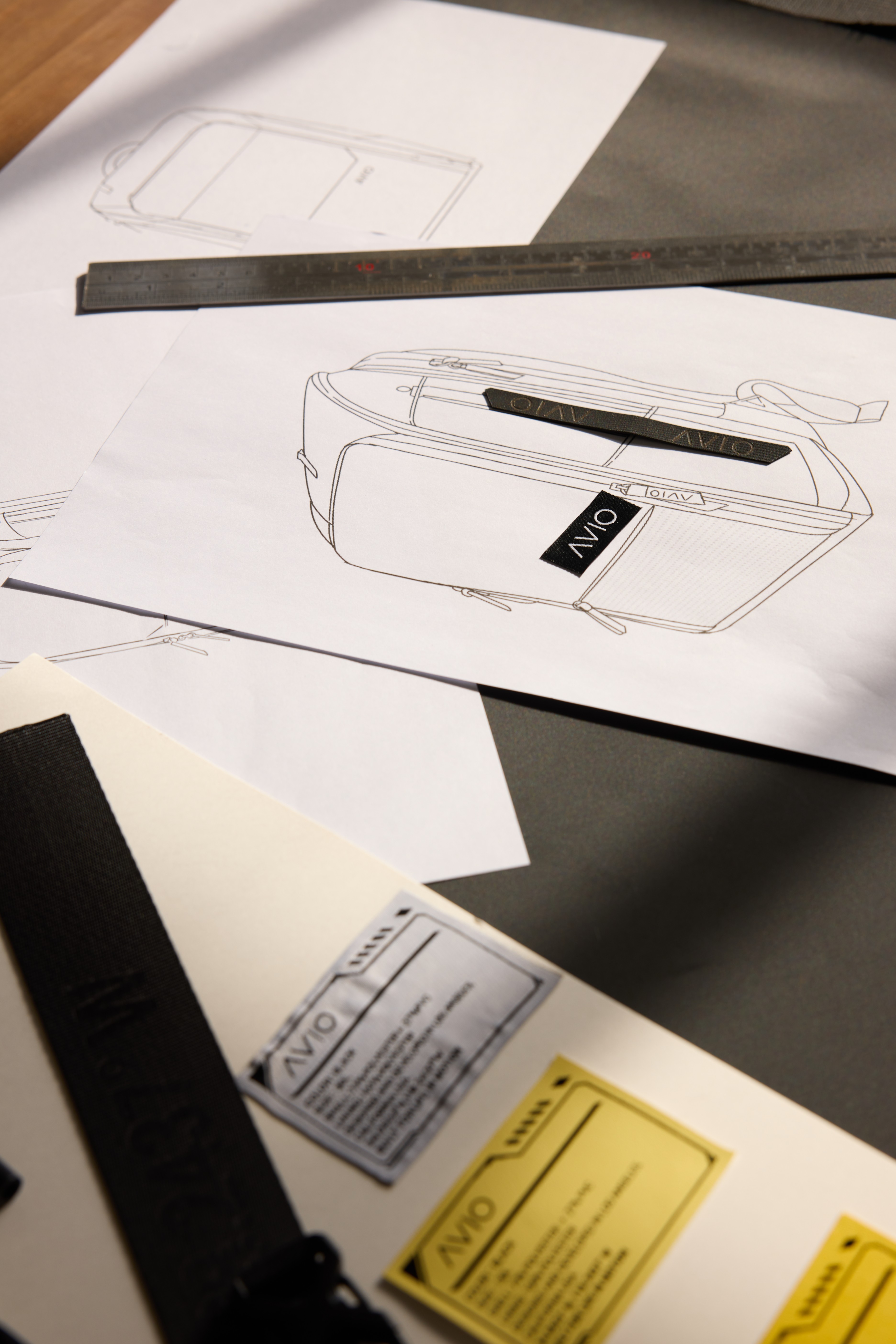 Sketches and labels of a bag design on a table.