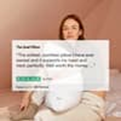 A woman sits on a bed holding a white pillow, with a positive customer review graphic overlaid.