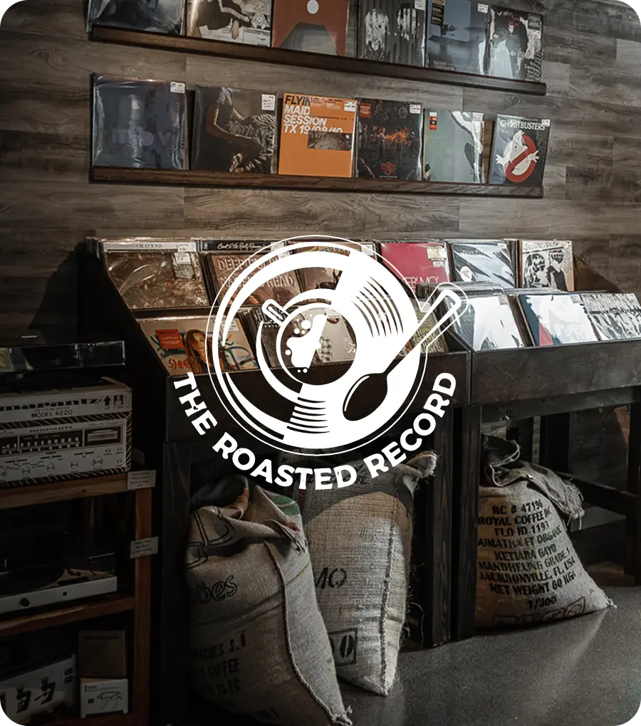 Vinyl records displayed on shelves with 'The Roasted Record' logo overlay.