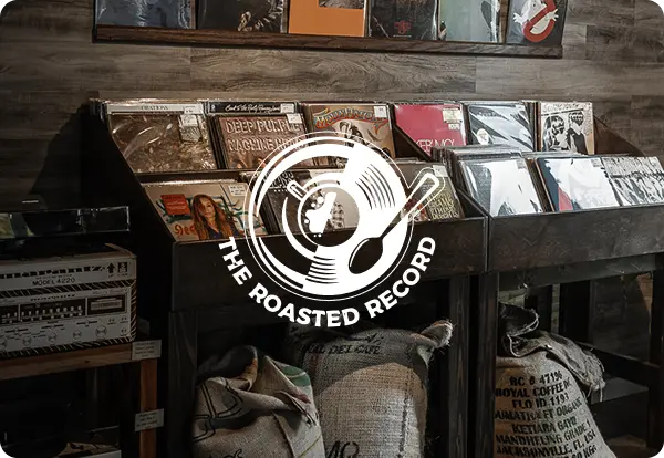 Vinyl records displayed on shelves with coffee sacks below, logo overlayed.