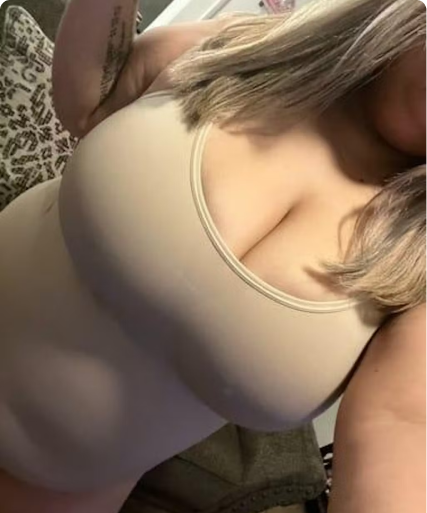 Person wearing a beige tank top, partially visible.