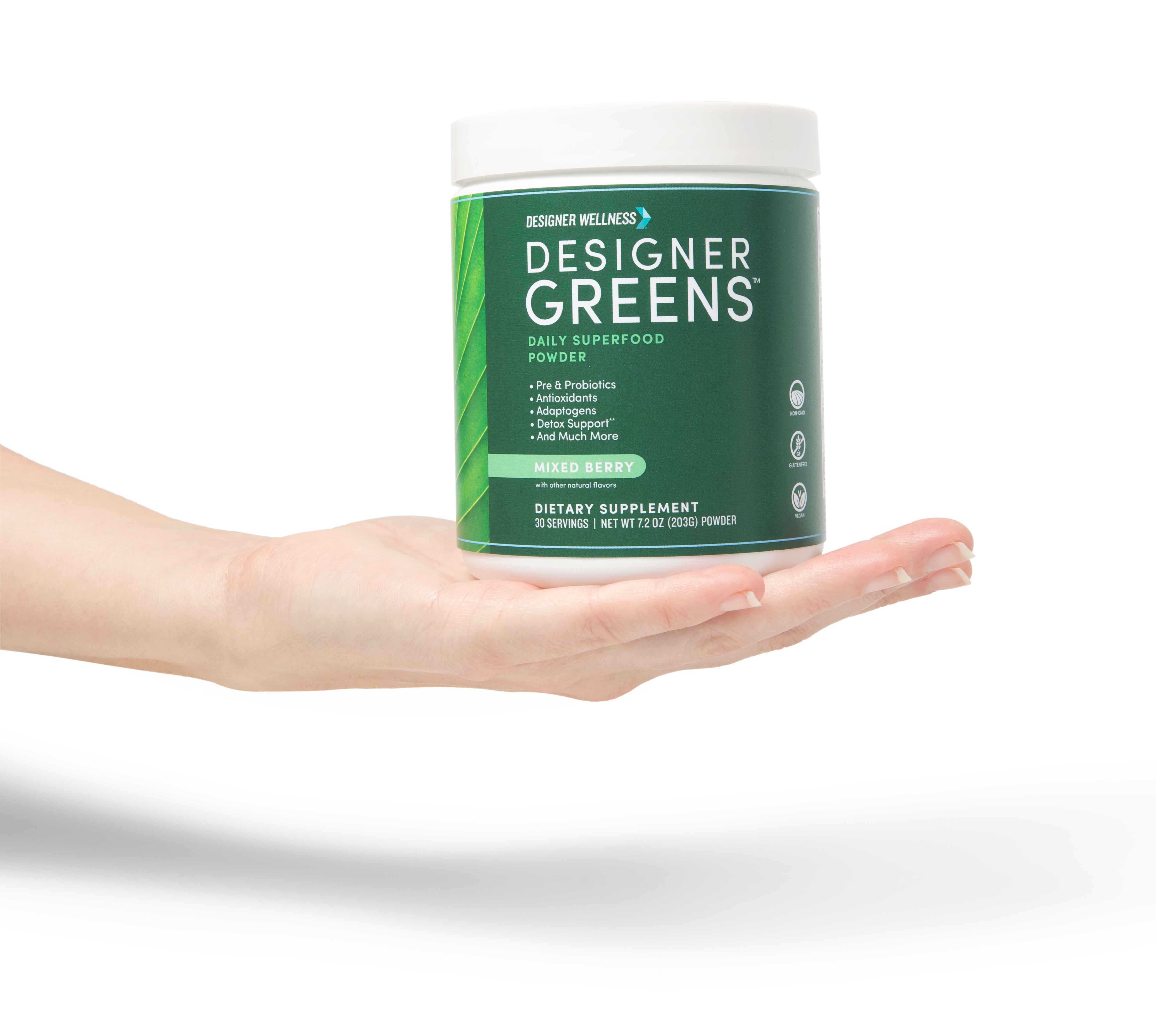 Hand holding a container of Designer Greens superfood powder.