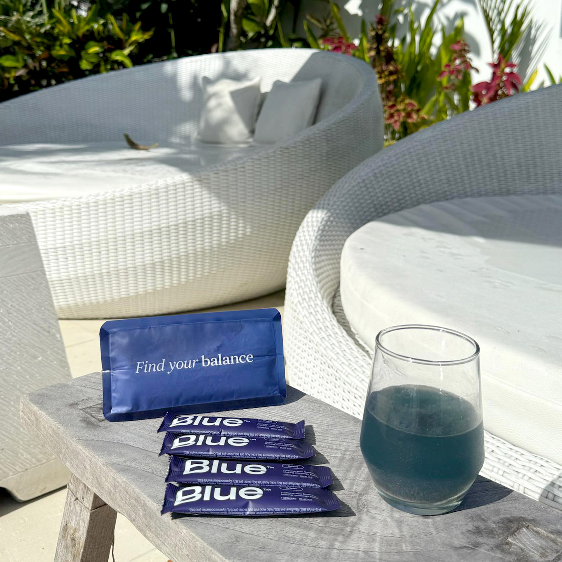 Outdoor seating with a drink, snacks, and a 'Find your balance' sign.