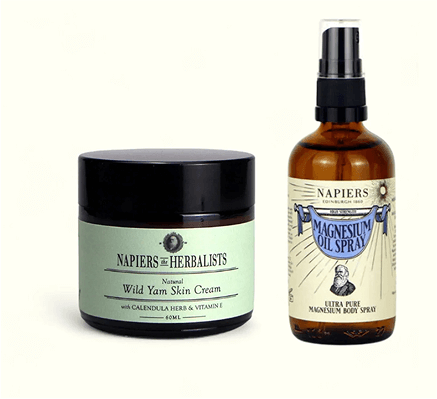 Two bottles labeled as herbal skin cream and magnesium oil spray.